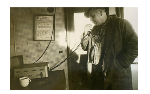 Sepia-toned illustration of Captain Jack in the steering house of his tugboat