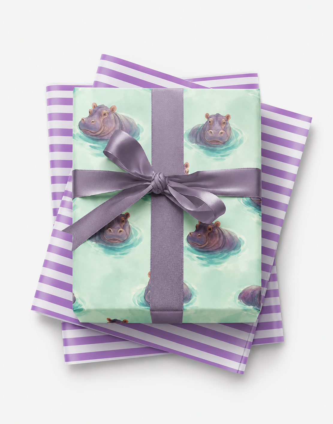 Watercolor hippo wrapping paper in mint with lavender satin bow and purple striped tissue
